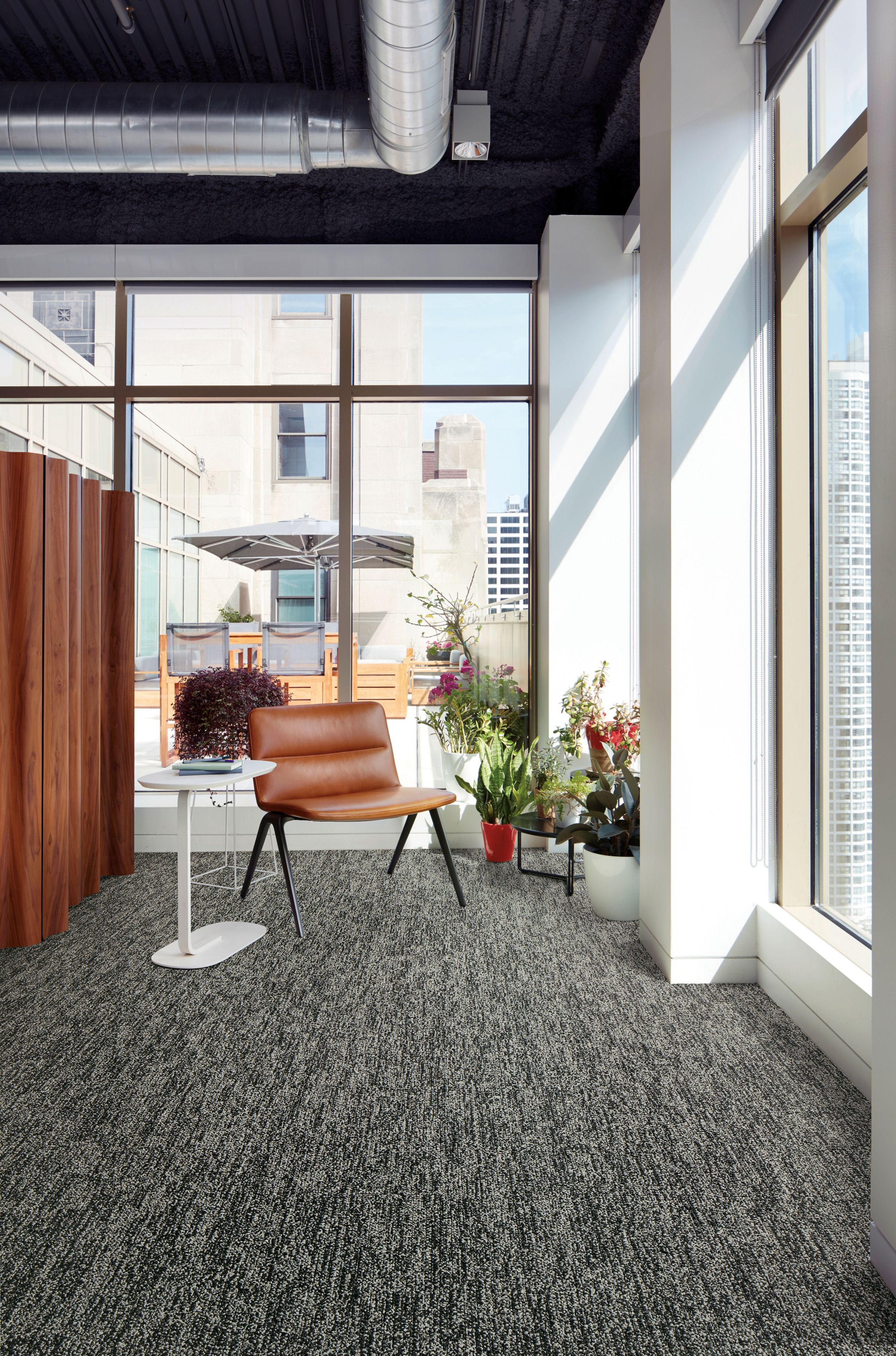 Interface Obligato plank carpet tile with leather chair and potted plants in windows image number 1